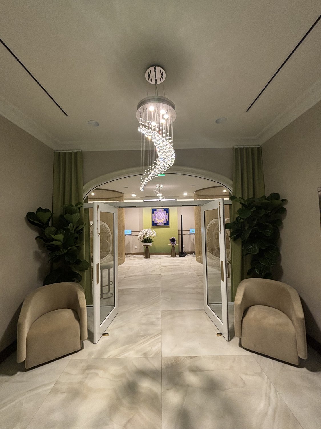 The Institute entrance — crystal chandelier, arched glass doors and the flower-of-life mandala.